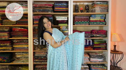 sky blue smooth chiffon saree with small floral prints