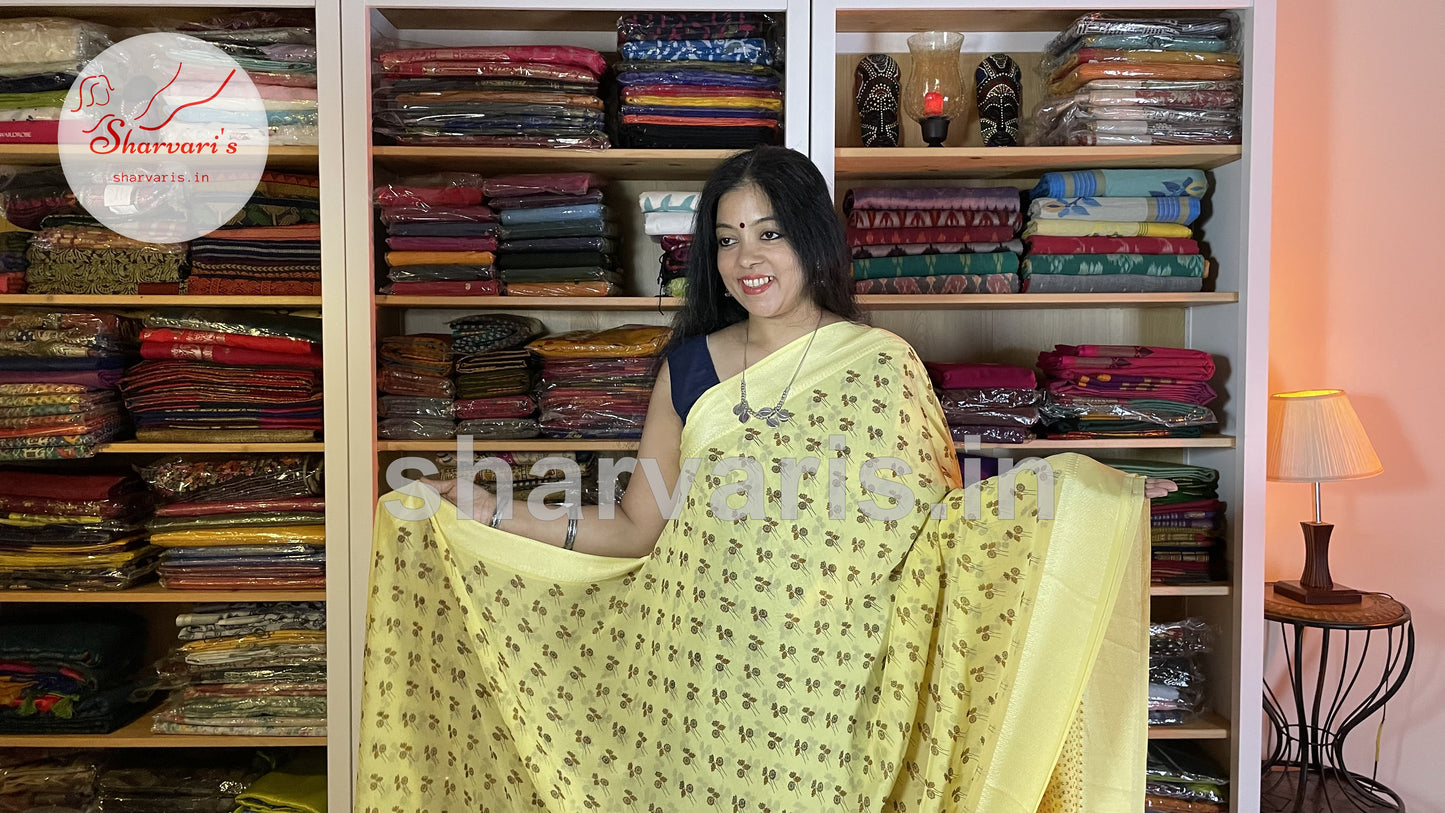 lemon yellow smooth chiffon saree with floral prints